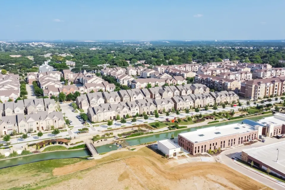Top view new development riverside residential and commercial neighborhood with vacant land in Texas, USA.